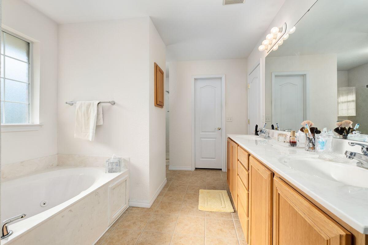 621 East Shipwreck Road Santa Rosa Beach, FL 32459 - Photo 15 of 25 a spacious bathroom with a tub sink and mirror