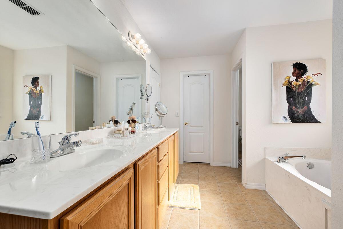 621 East Shipwreck Road Santa Rosa Beach, FL 32459 - Photo 16 of 25 a en suite bathroom with a double vanity sink and a bathtub