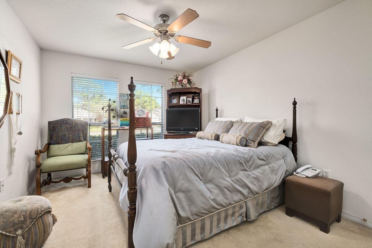 621 East Shipwreck Road Santa Rosa Beach, FL 32459 - Photo 19 of 25 a spacious bedroom with a bed a couch and a chandelier