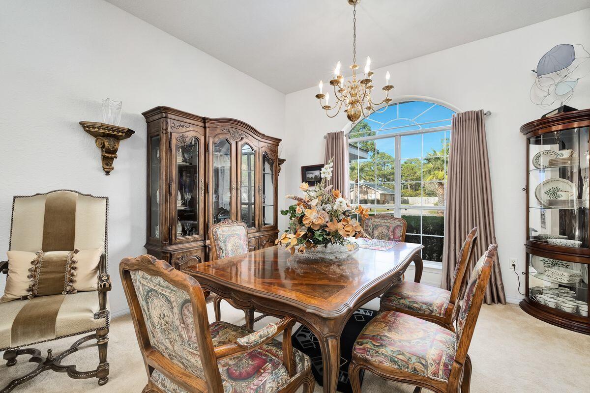 621 East Shipwreck Road Santa Rosa Beach, FL 32459 - Photo 4 of 25 a view of a dining room with furniture and chandelier