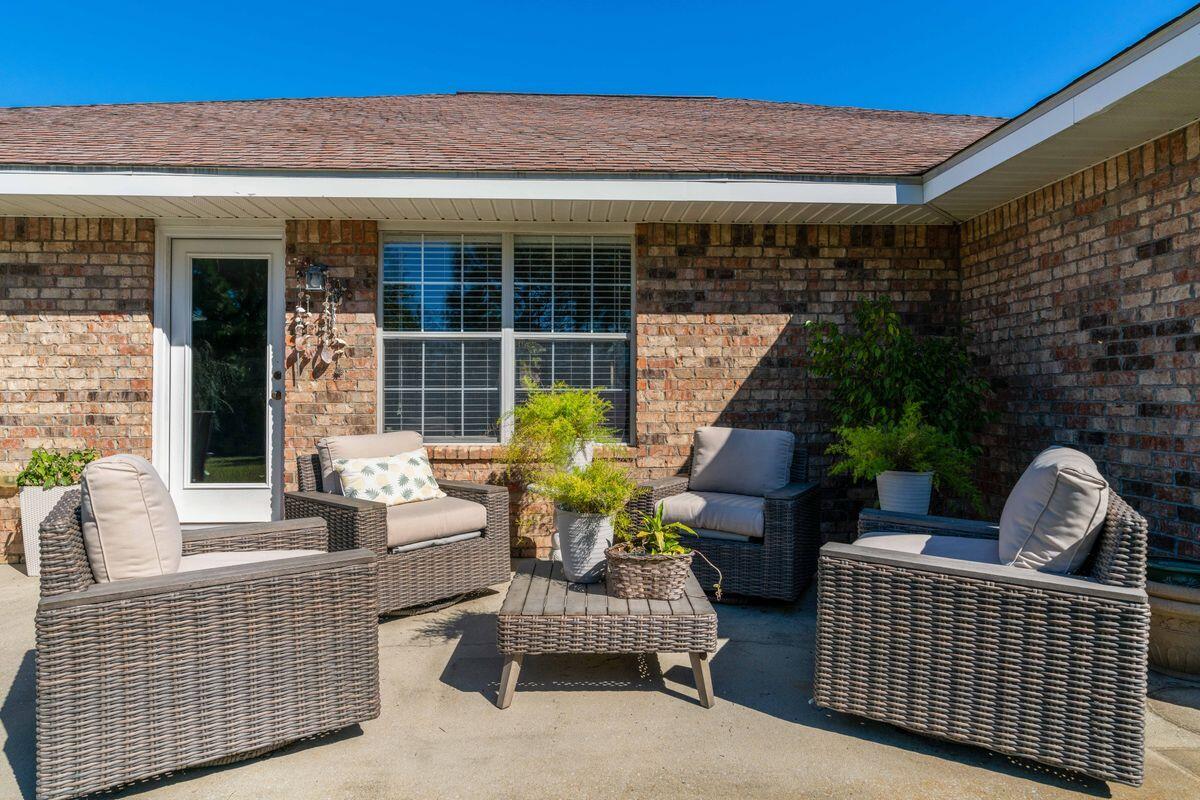 621 East Shipwreck Road Santa Rosa Beach, FL 32459 - Photo 6 of 25 a view of a patio with couches chairs and potted plants