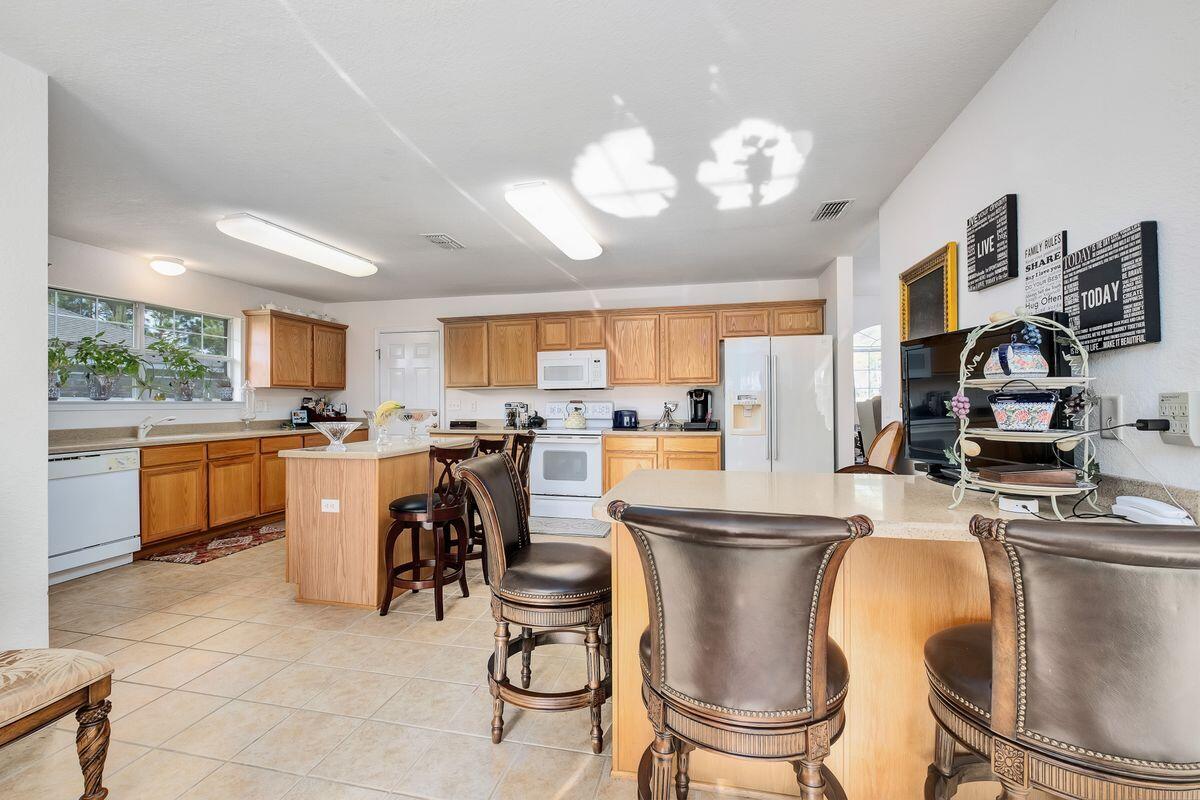 621 East Shipwreck Road Santa Rosa Beach, FL 32459 - Photo 8 of 25 a kitchen with a dining table chairs sink and stove