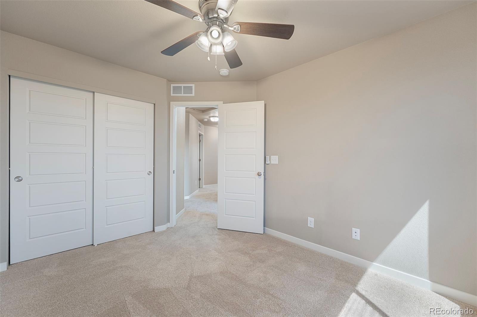 9528 Timberlake Loop Colorado Springs, CO 80927 - Photo 24 of 37 a view of an empty room and a chandelier fan