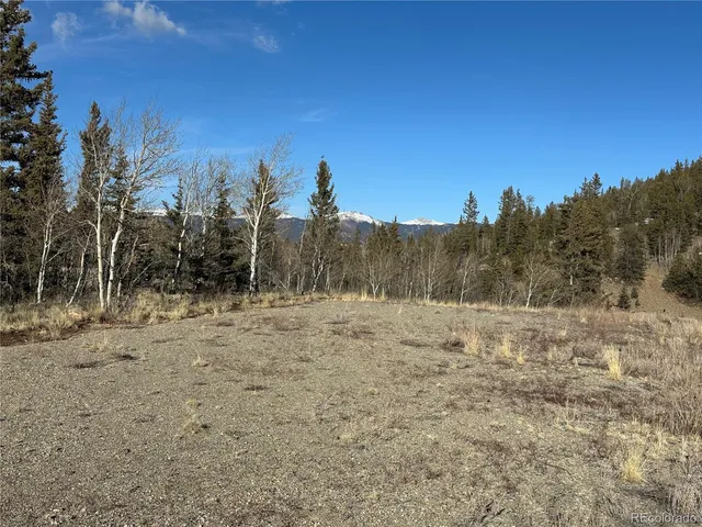 a view of dirt road with a building in the background
