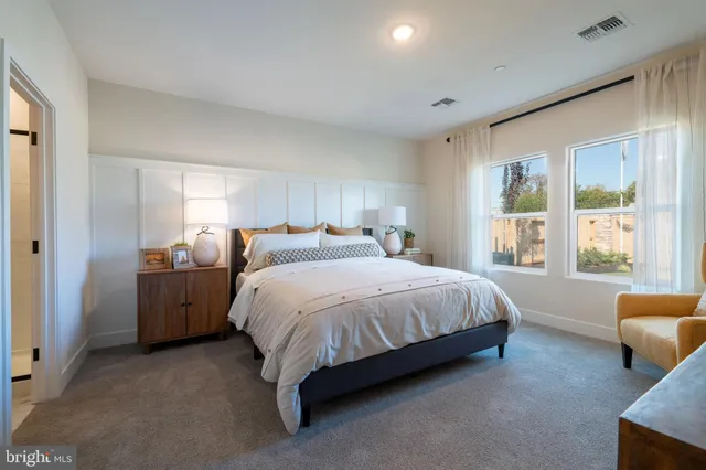 a spacious bedroom with a bed and a couch