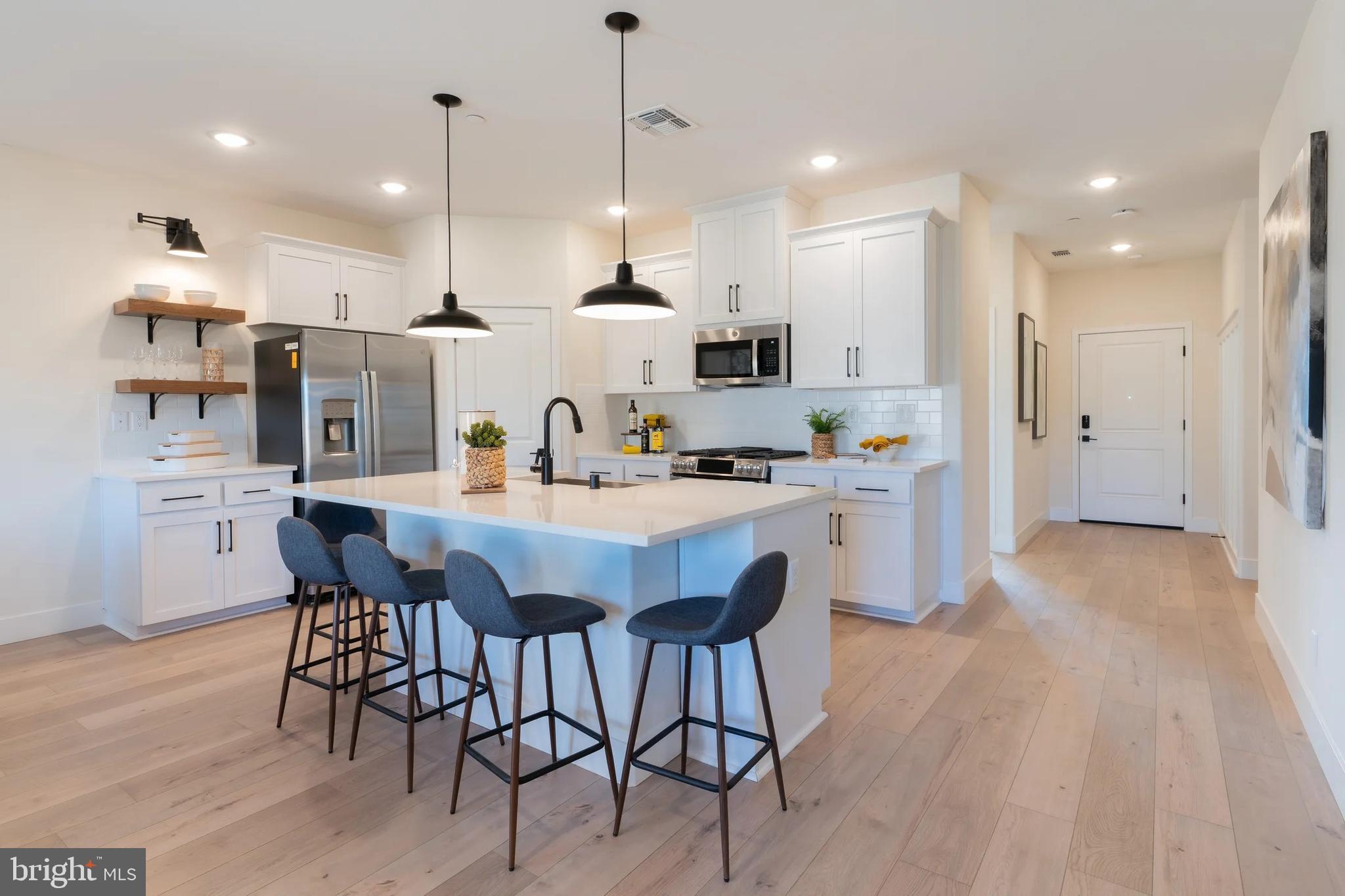 106 Thornton Avenue Ranson, WV 25438 - Photo 4 of 29 a large kitchen with a table and chairs