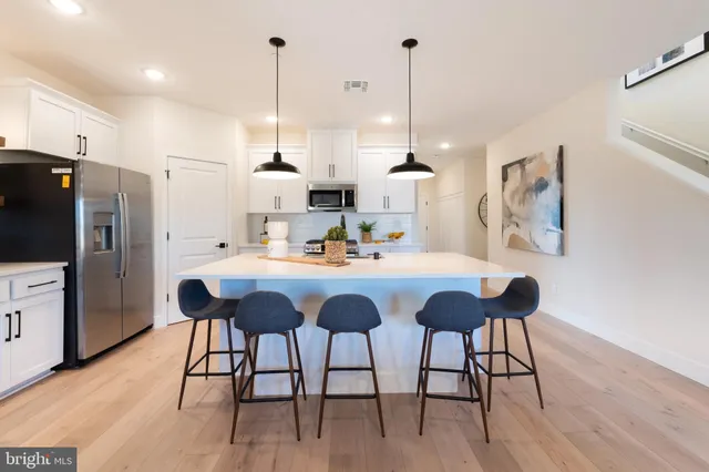 a view of kitchen with dining room and wooden floor