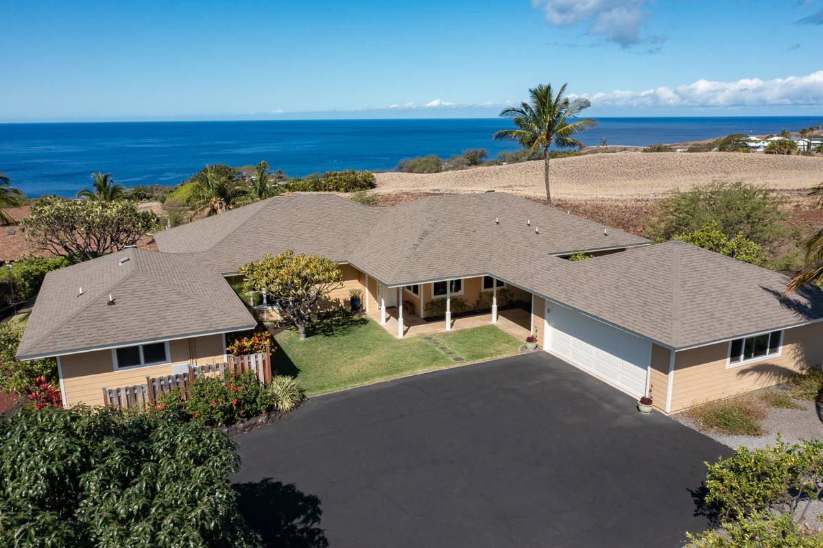 an aerial view of a house and ocean view