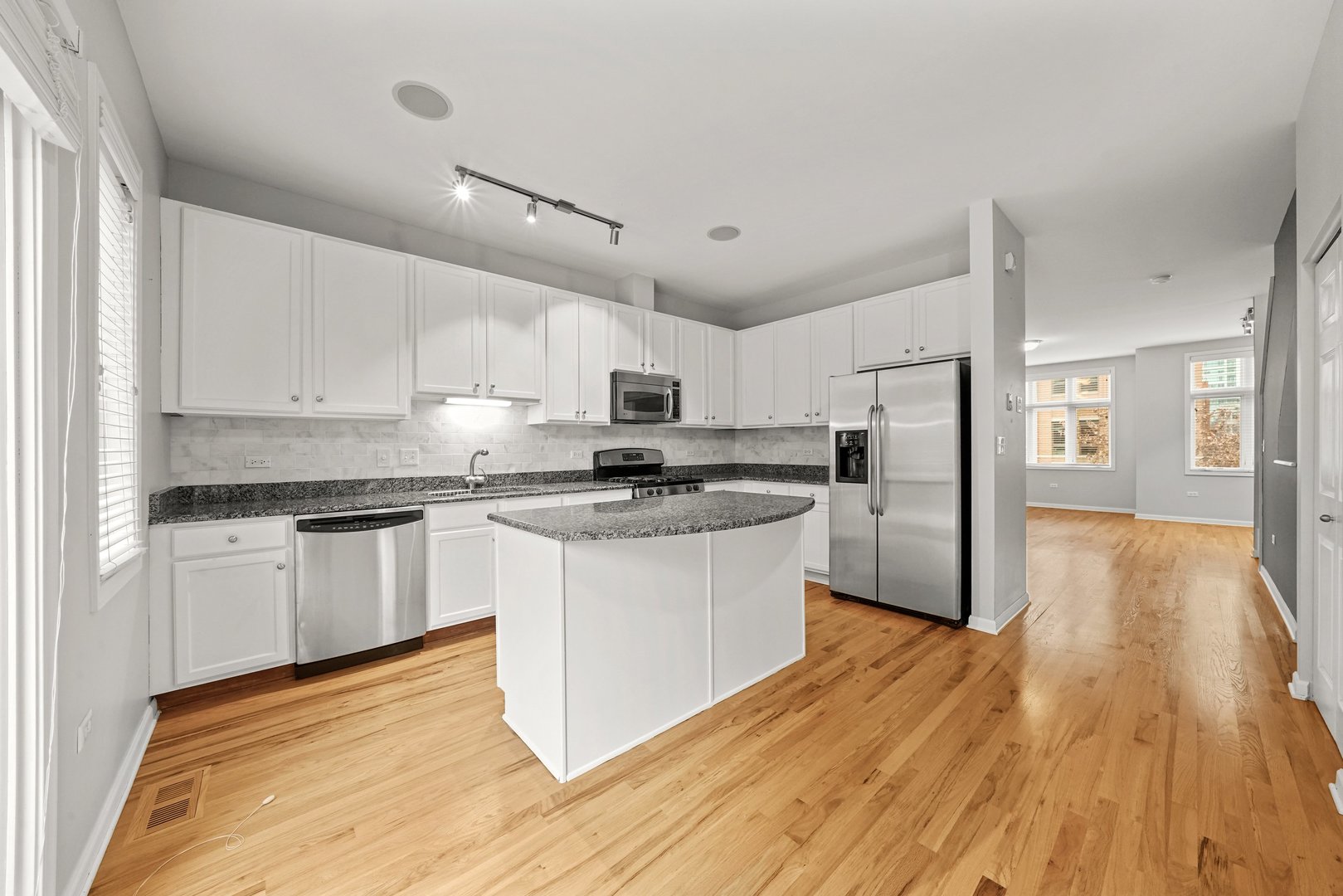 1703 South Prairie Avenue Chicago, IL 60616 - Photo 11 of 34 a kitchen with granite countertop a refrigerator and wooden floors