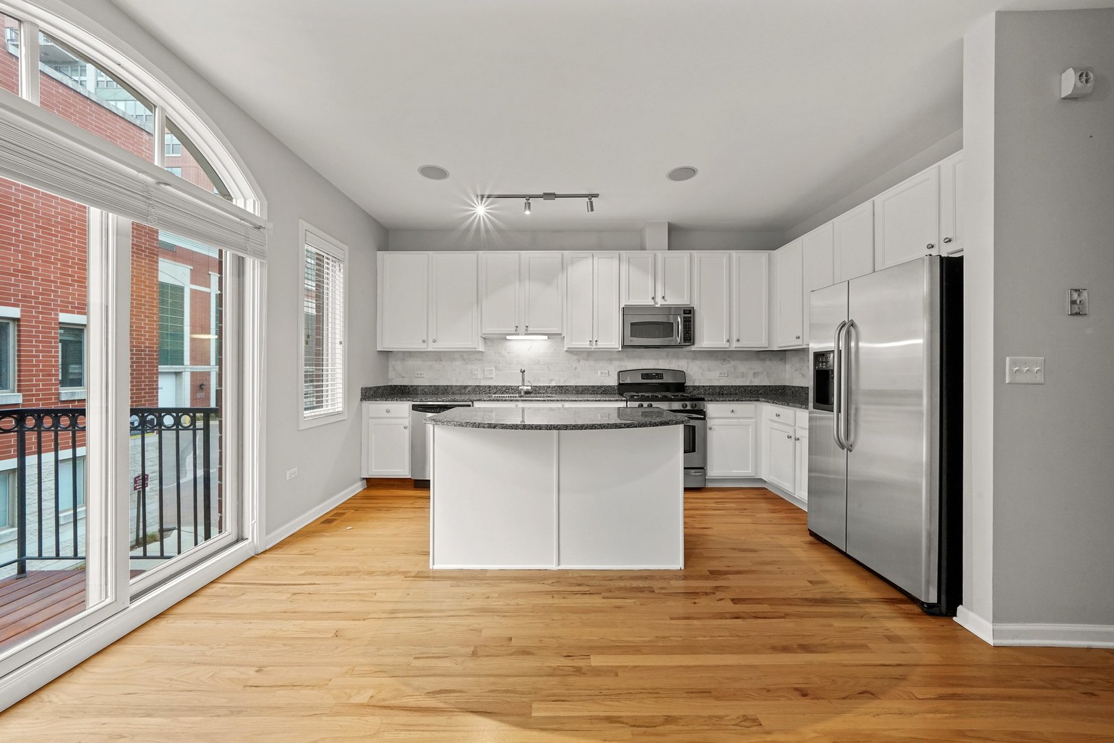 1703 South Prairie Avenue Chicago, IL 60616 - Photo 12 of 34 a large kitchen with a center island wooden floor stainless steel appliances and cabinets