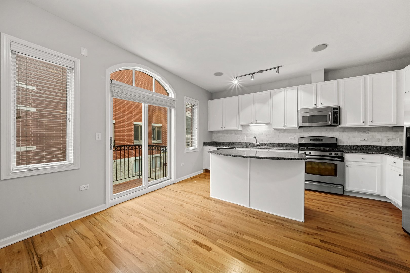 1703 South Prairie Avenue Chicago, IL 60616 - Photo 13 of 34 a kitchen with granite countertop a stove a sink and a microwave