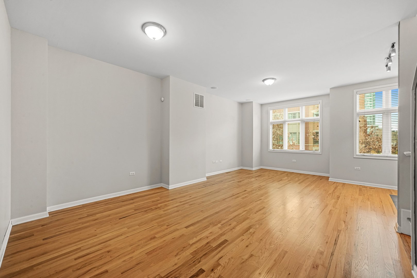 1703 South Prairie Avenue Chicago, IL 60616 - Photo 14 of 34 a view of an empty room with wooden floor and a window