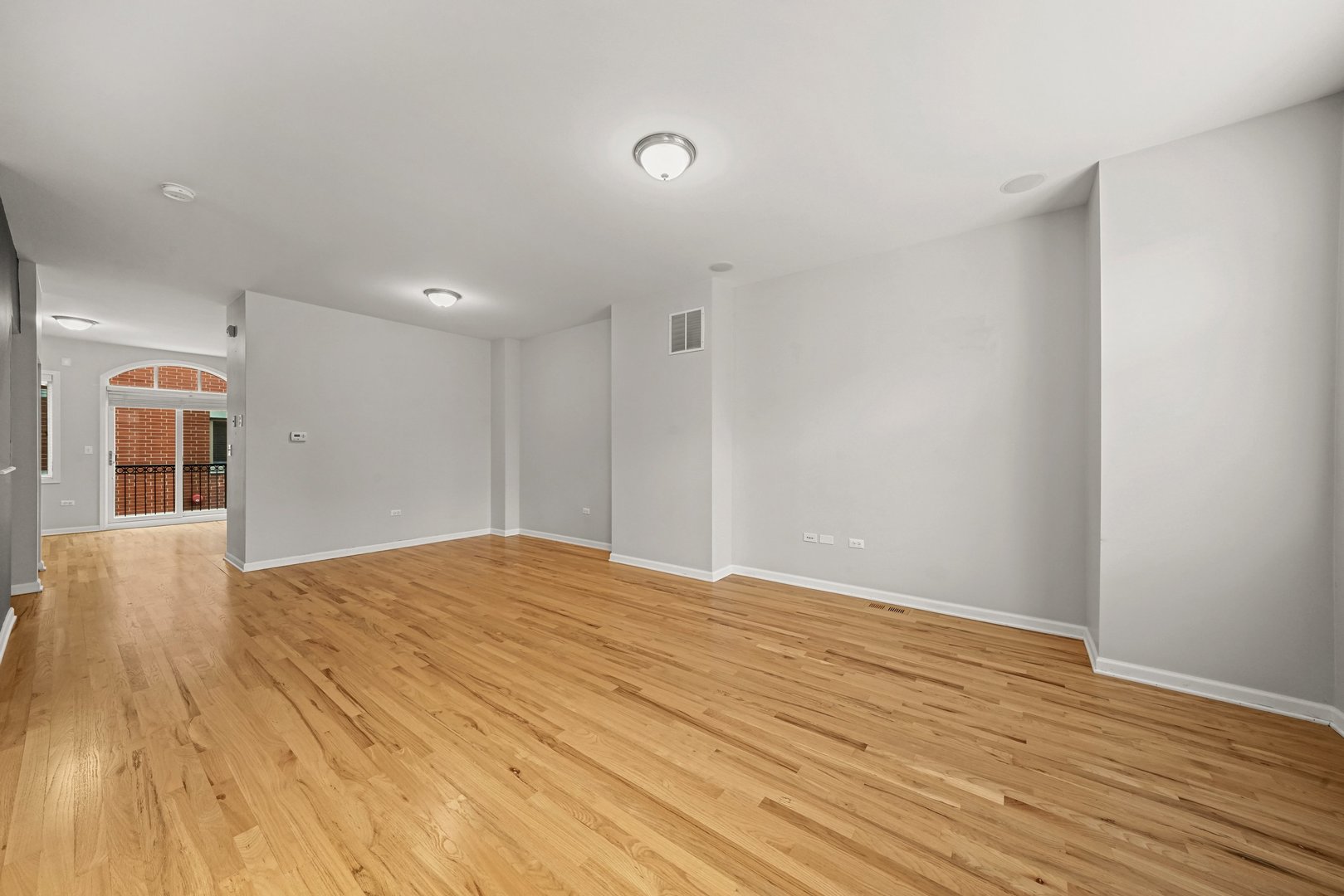 1703 South Prairie Avenue Chicago, IL 60616 - Photo 20 of 34 a view of an empty room with wooden floor and a window