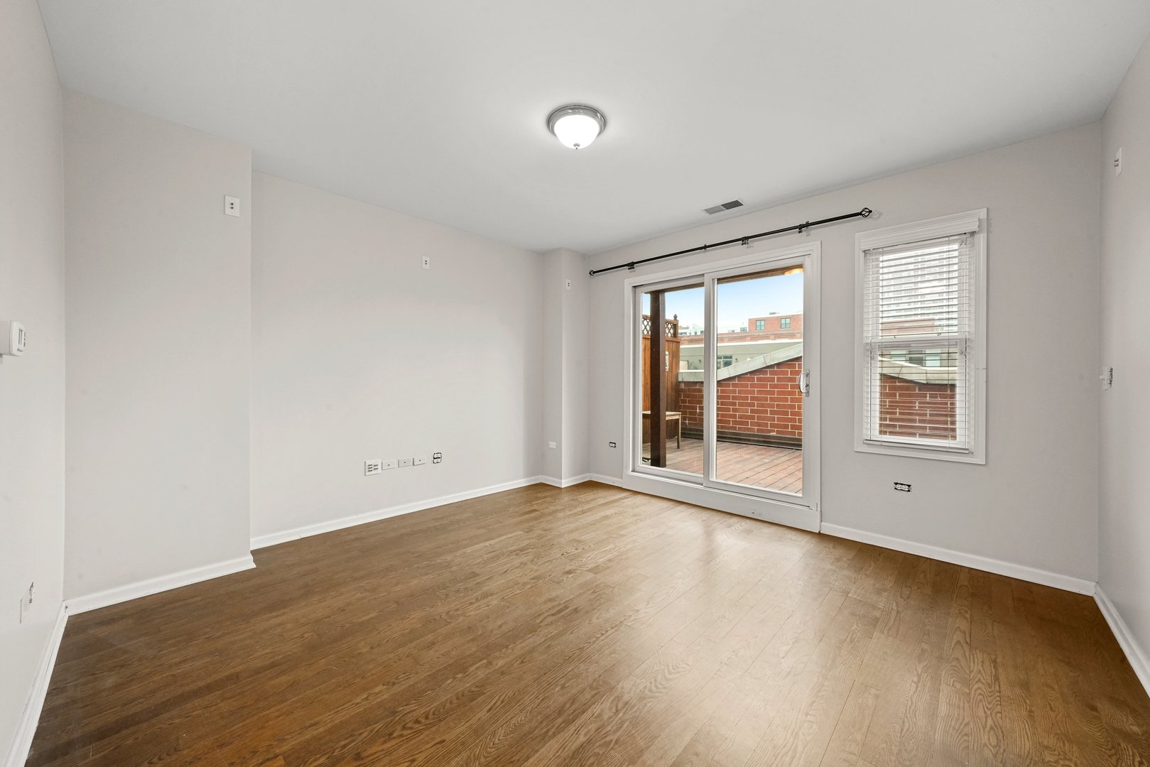 1703 South Prairie Avenue Chicago, IL 60616 - Photo 27 of 34 a view of an empty room with a window and wooden floor