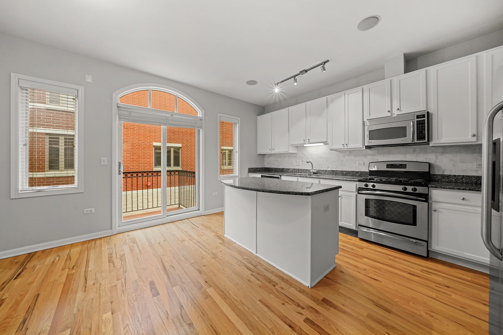 1703 South Prairie Avenue Chicago, IL 60616 - Photo 7 of 34 a kitchen with stainless steel appliances granite countertop a stove a sink and a microwave
