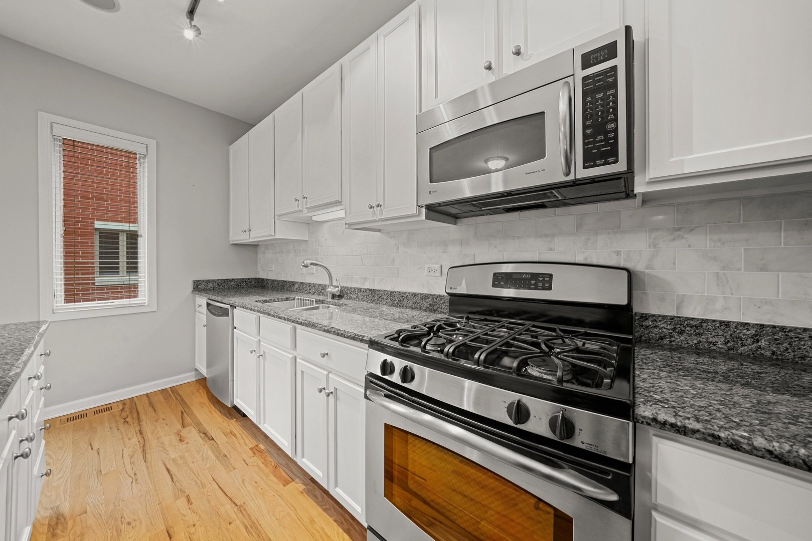 1703 South Prairie Avenue Chicago, IL 60616 - Photo 8 of 34 a kitchen with stainless steel appliances granite countertop a stove and a microwave