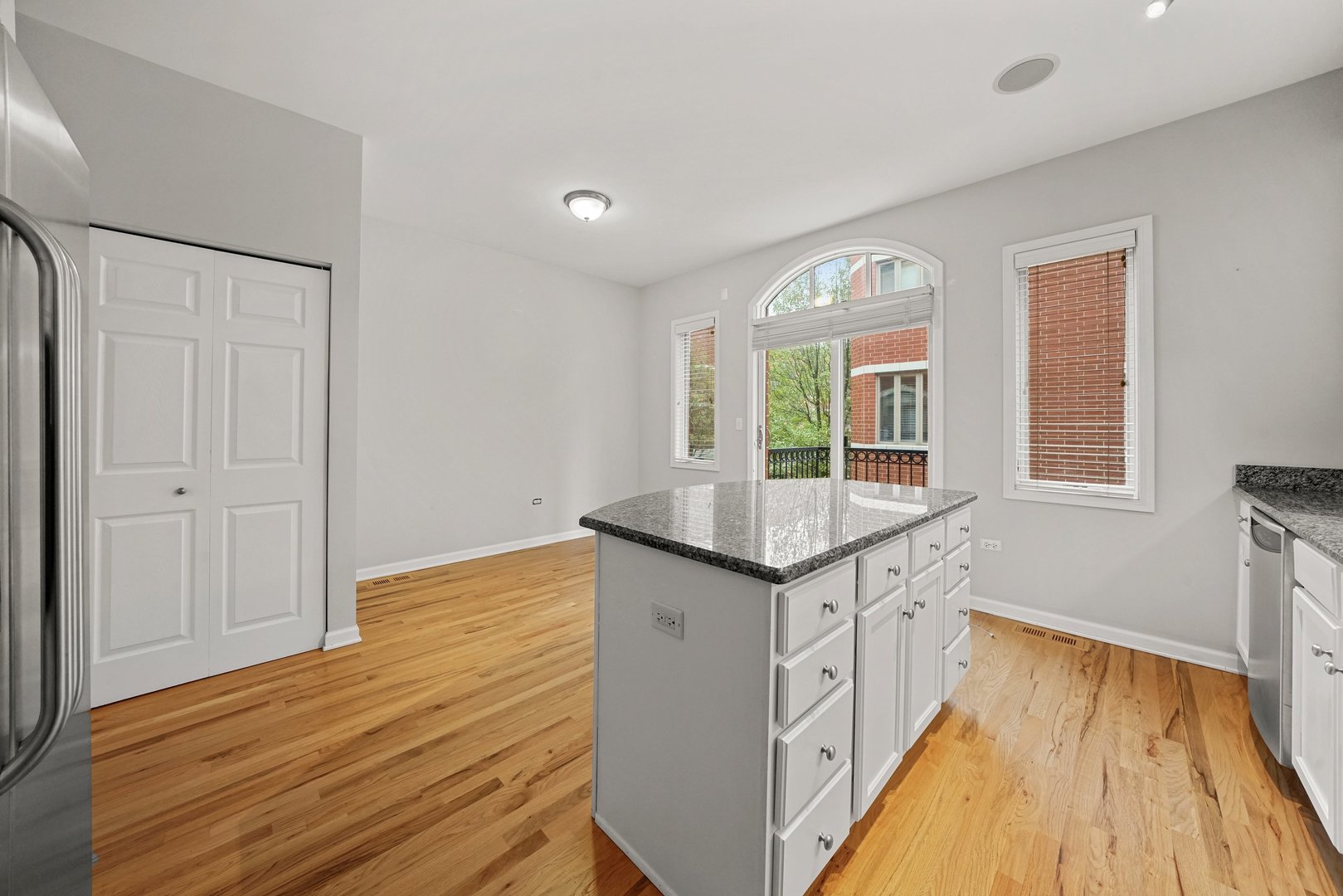 1703 South Prairie Avenue Chicago, IL 60616 - Photo 9 of 34 a view of a kitchen counter space with wooden floor and staircase