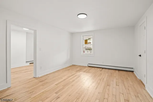 a view of hallway with wooden floor