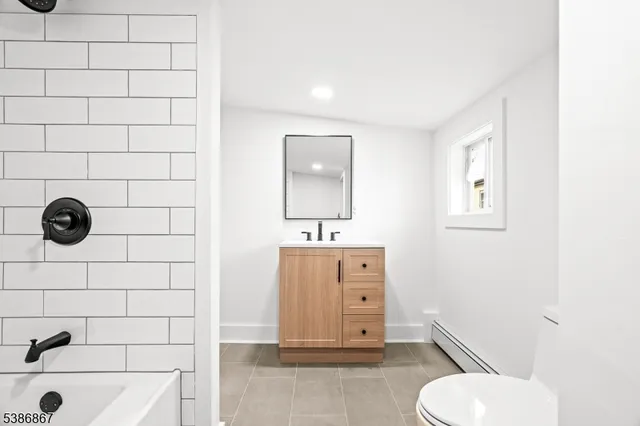 a bathroom with a toilet and a bathtub