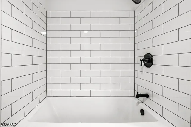 a bedroom with a large bed and a potted plant