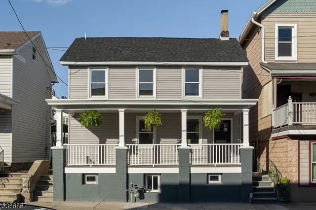 a kitchen with white cabinets and appliances