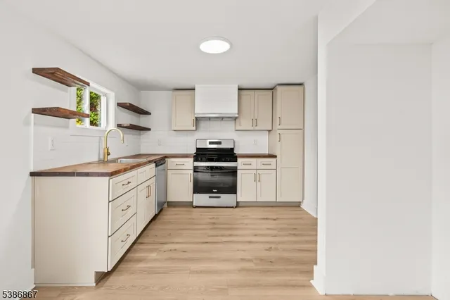 a kitchen with granite countertop a stove and a sink
