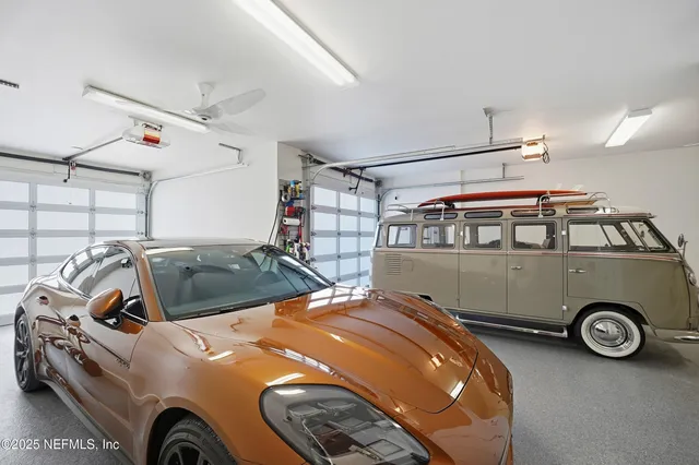a living room with furniture and floor to ceiling windows