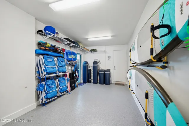 a living room with furniture and floor to ceiling windows