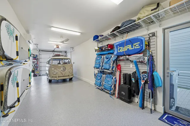 a living room with kitchen island granite countertop furniture and a flat screen tv