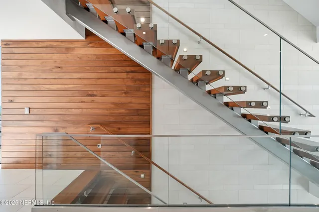 a living room with furniture large windows and a flat screen tv