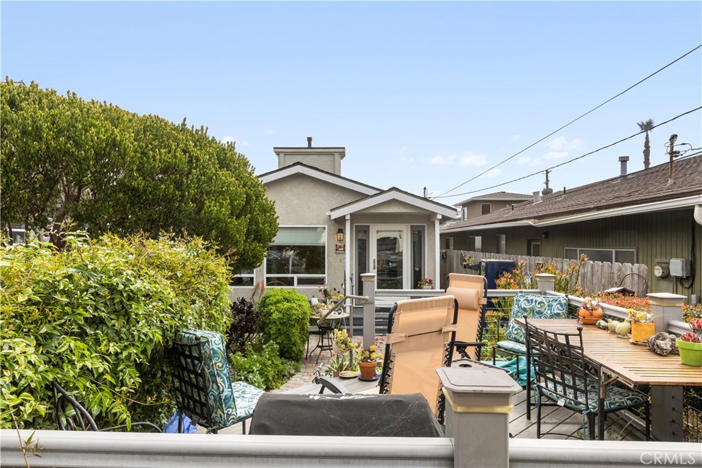 50 5th Street Cayucos, CA 93430 - Photo 13 of 47 a view of a patio with table and chairs potted plants and large tree