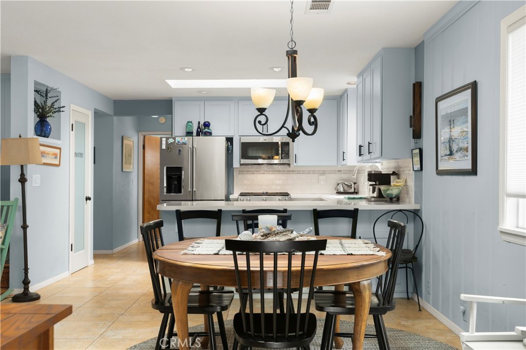 50 5th Street Cayucos, CA 93430 - Photo 19 of 47 a view of a dining room with furniture a kitchen and chandelier
