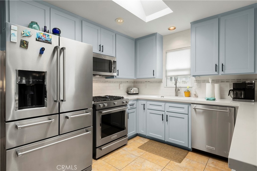 50 5th Street Cayucos, CA 93430 - Photo 23 of 47 a kitchen with stainless steel appliances granite countertop a refrigerator sink and stove