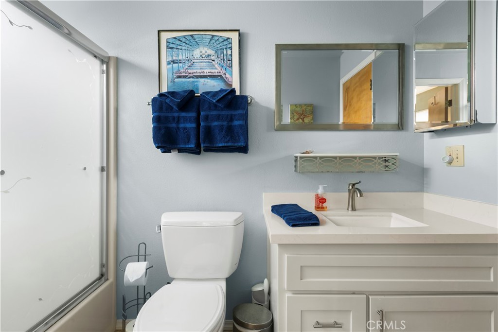 50 5th Street Cayucos, CA 93430 - Photo 33 of 47 a bathroom with a toilet a sink and mirror