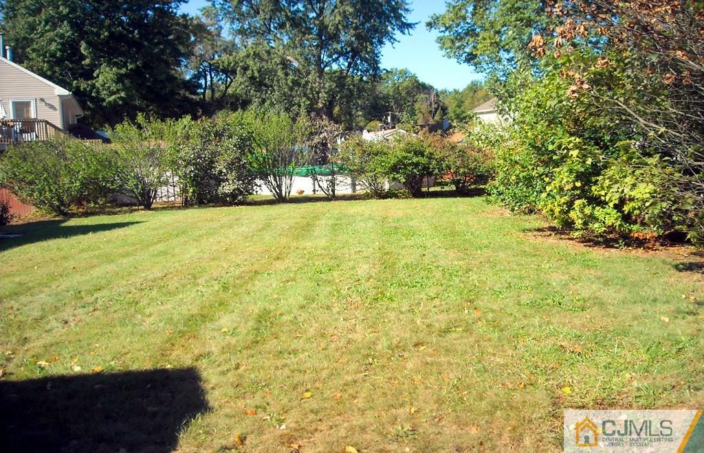 31 Markham Road Edison, NJ 08817 - Photo 12 of 13 a view of yard with swimming pool and trees in background