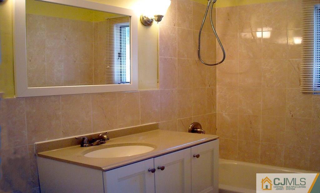 31 Markham Road Edison, NJ 08817 - Photo 9 of 13 a bathroom with a sink and a mirror