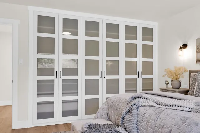 a bedroom with a bed and walk in closet