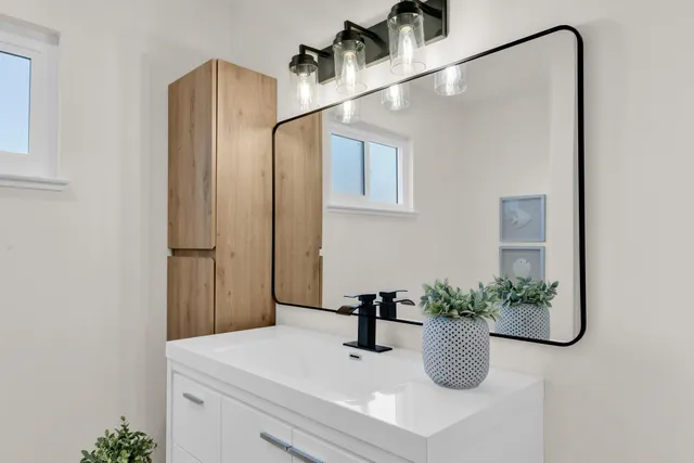 a bathroom with a sink a mirror and a shower