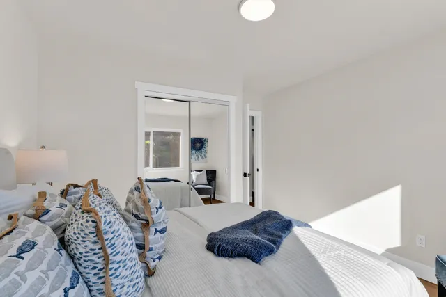 a bed room with a bed and a large mirror