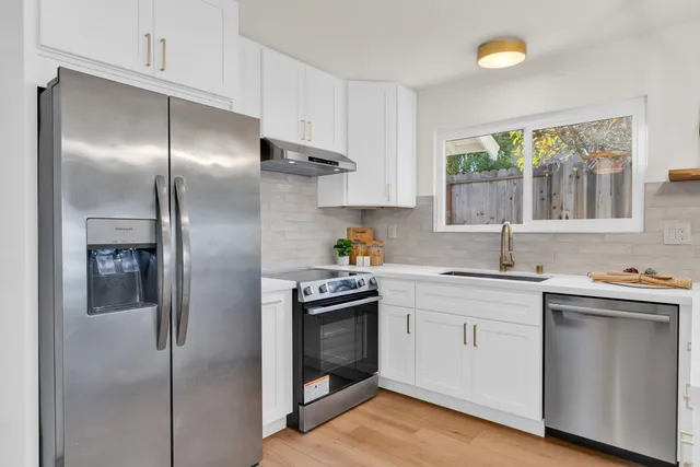 a kitchen with a sink stove and refrigerator