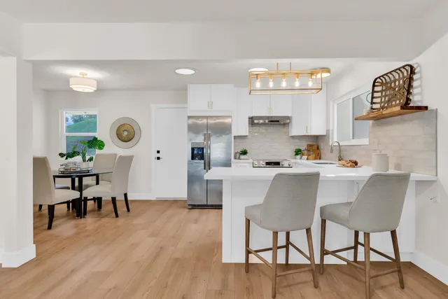 a kitchen with a table and chairs in it