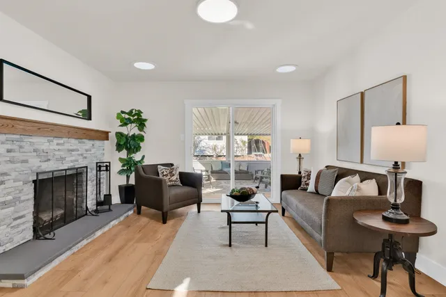 a living room with furniture and a fireplace