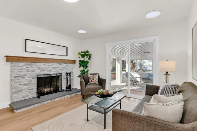 a living room with furniture and a fireplace