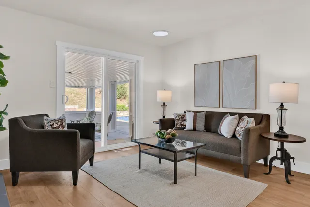 a living room with furniture and a large window
