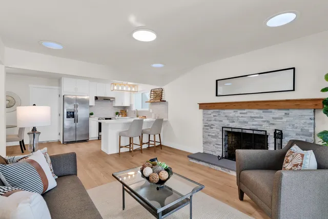 a living room with furniture and a fireplace