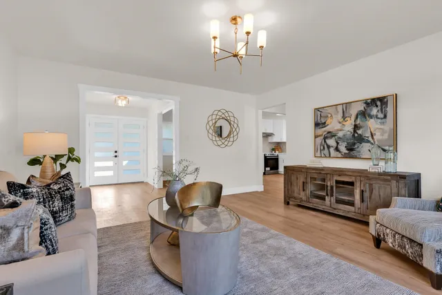 a living room with furniture and a chandelier