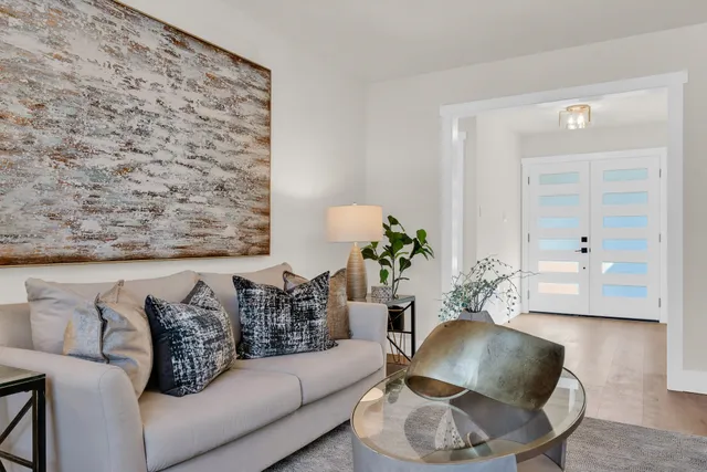 a living room with furniture and a potted plant