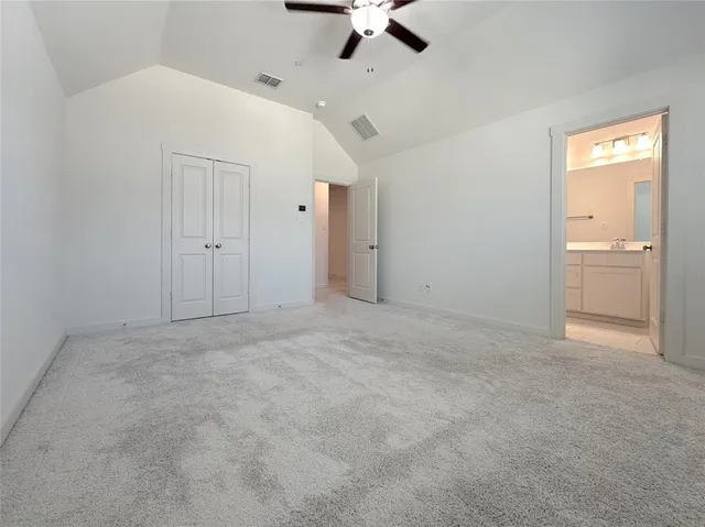 en empty room with a ceiling fan and window