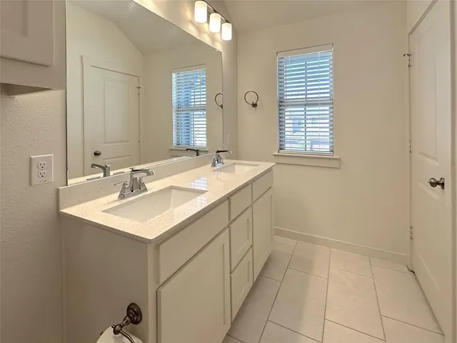 a bathroom with a sink vanity and a mirror