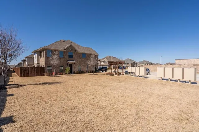 a view of large house with a yard covered in snow